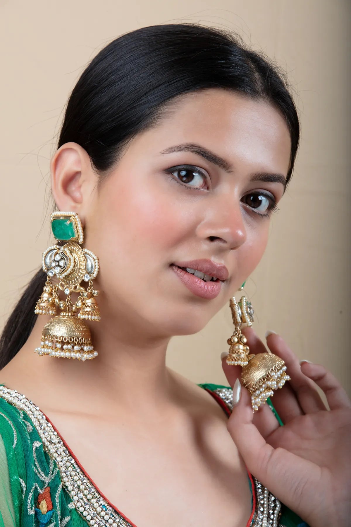 Heavy Golden Jhumka Earrings with Green Stone and Pearl Detailing